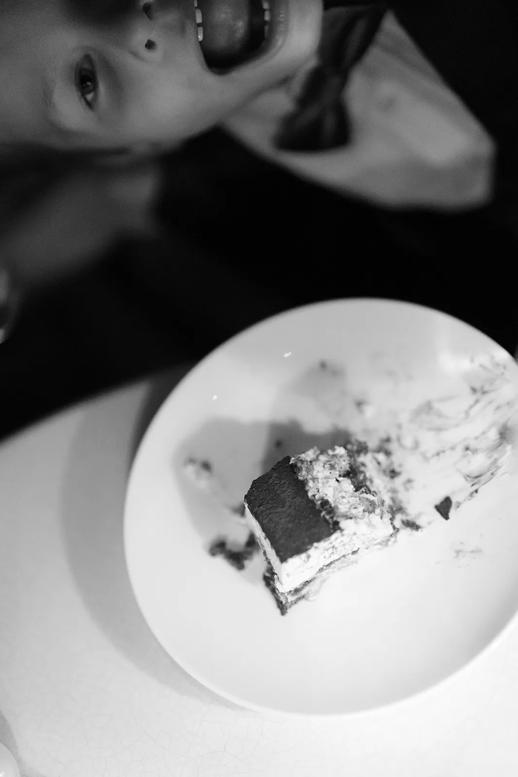 a plate with a half eaten wedding tiramisu cake and ring boy in the end
