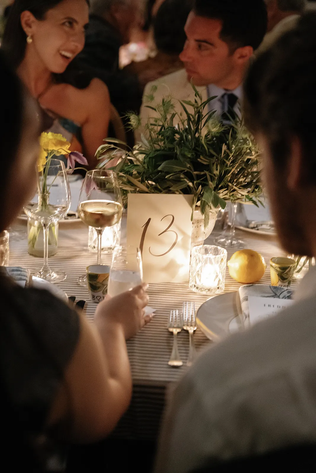 close up of table number 13 as the candle glows nearby