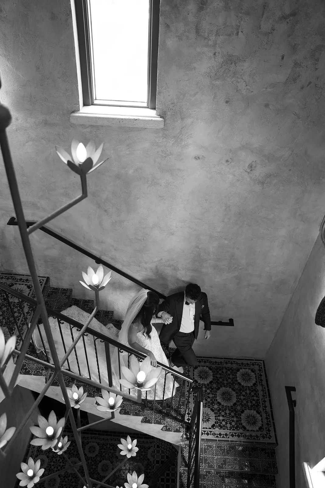 bride and groom walking down the stairs in the four seasons at the surf club