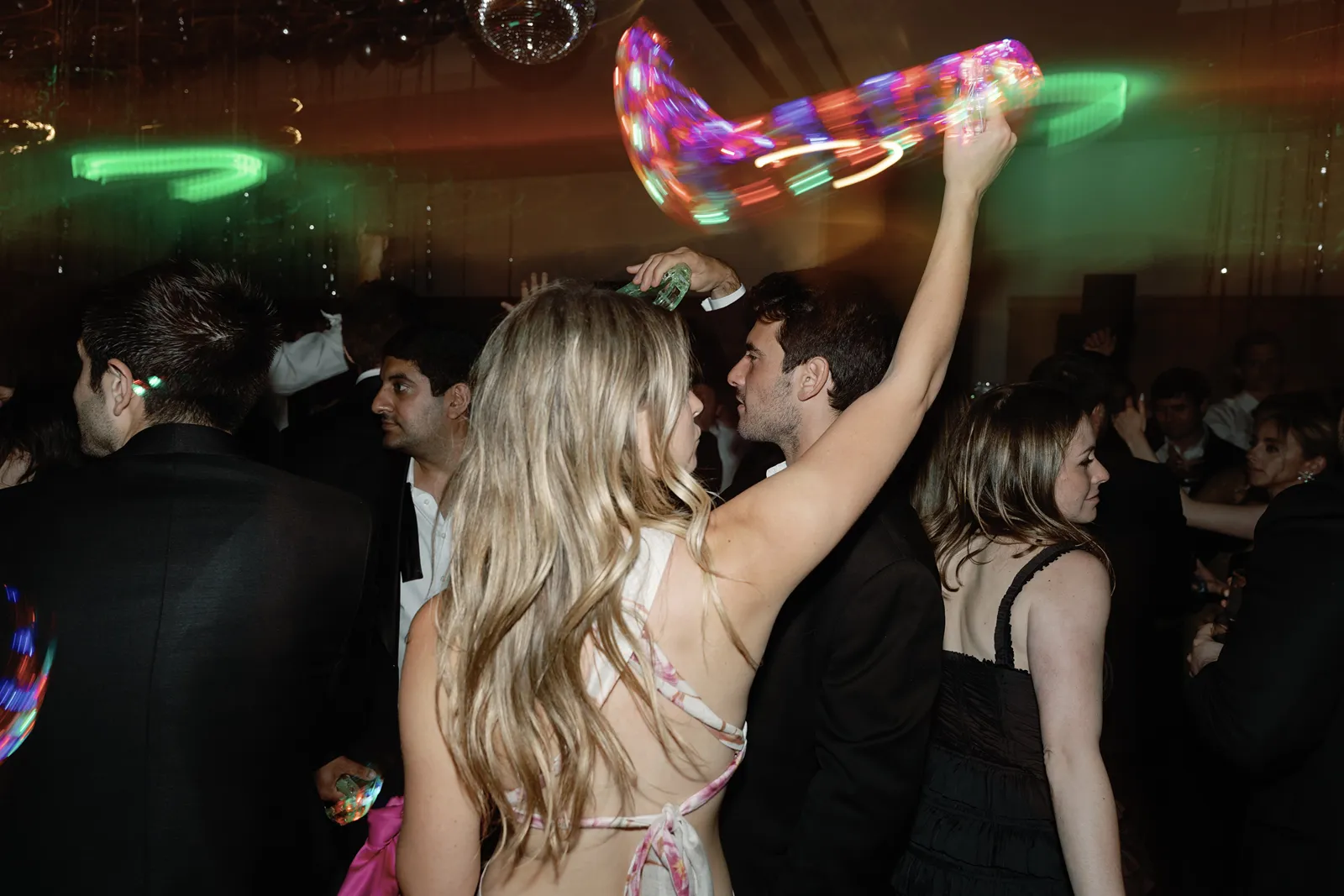 Wedding guest waving LED tambourine while dancing at Montage Healdsburg after party