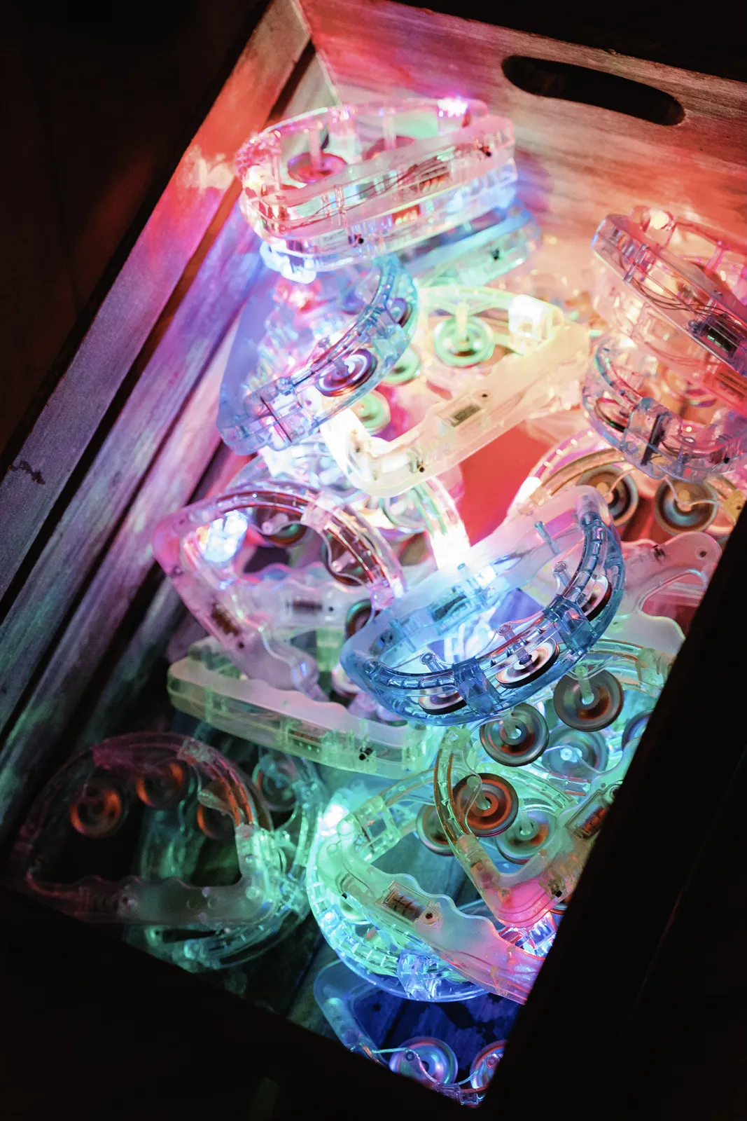 box of colorful lit up tambourines for guests to use