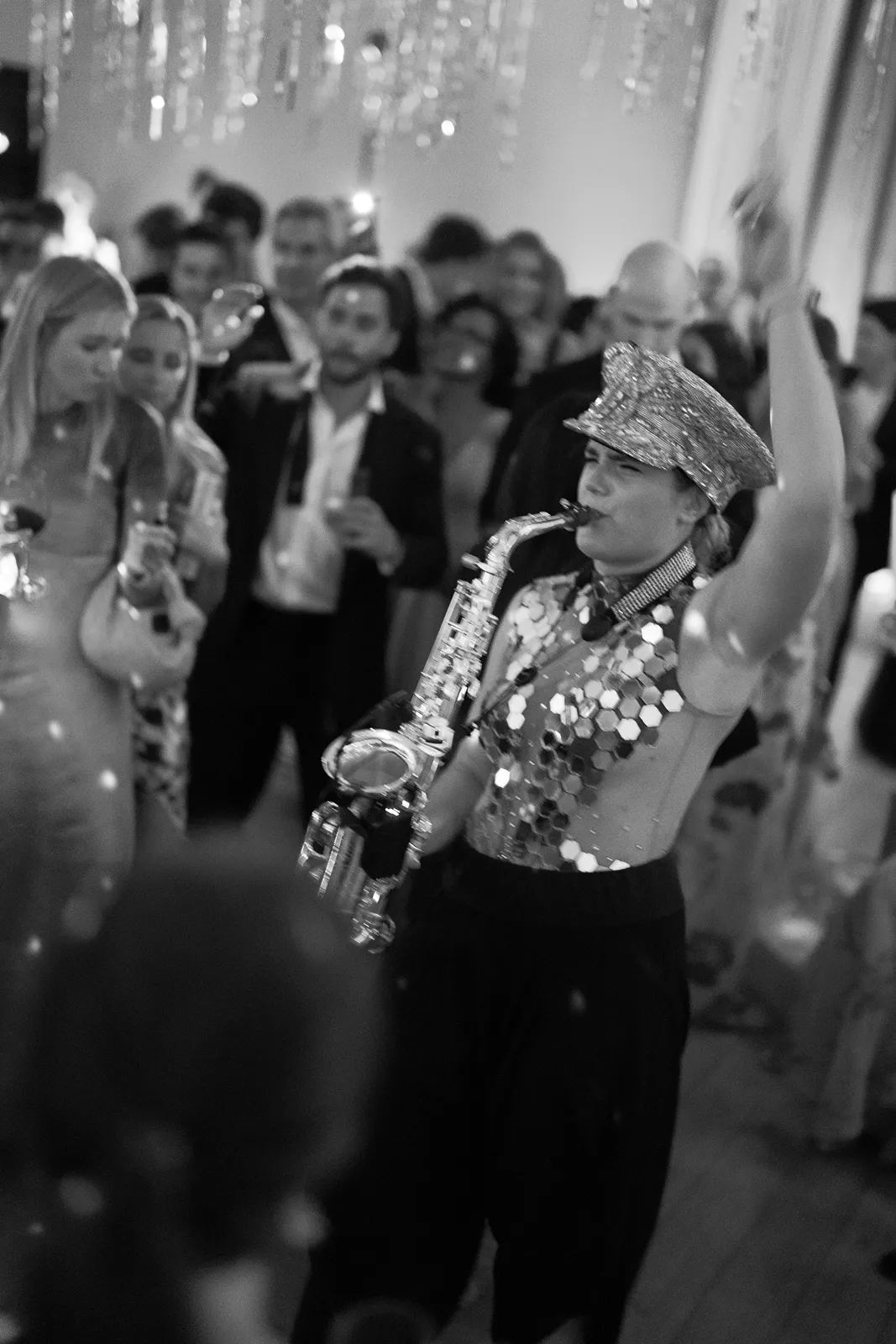 Live saxophonist performs on the dance floor as wedding guests gather and celebrate at a Montage Healdsburg reception after-party