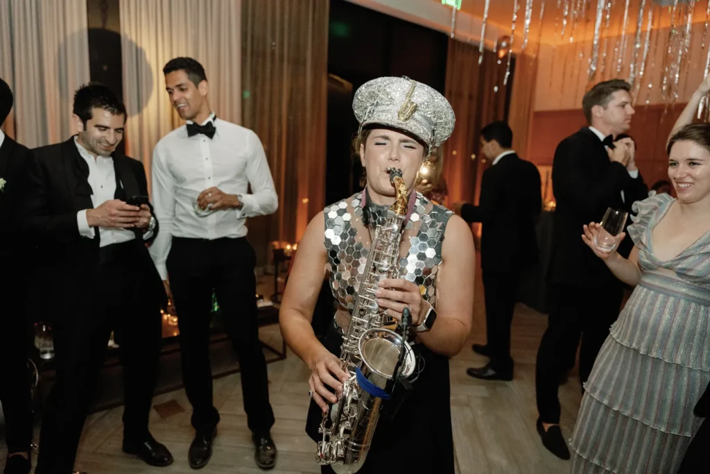 Live sax player performs among wedding guests on the dance floor during a luxury after-party at Montage Healdsburg