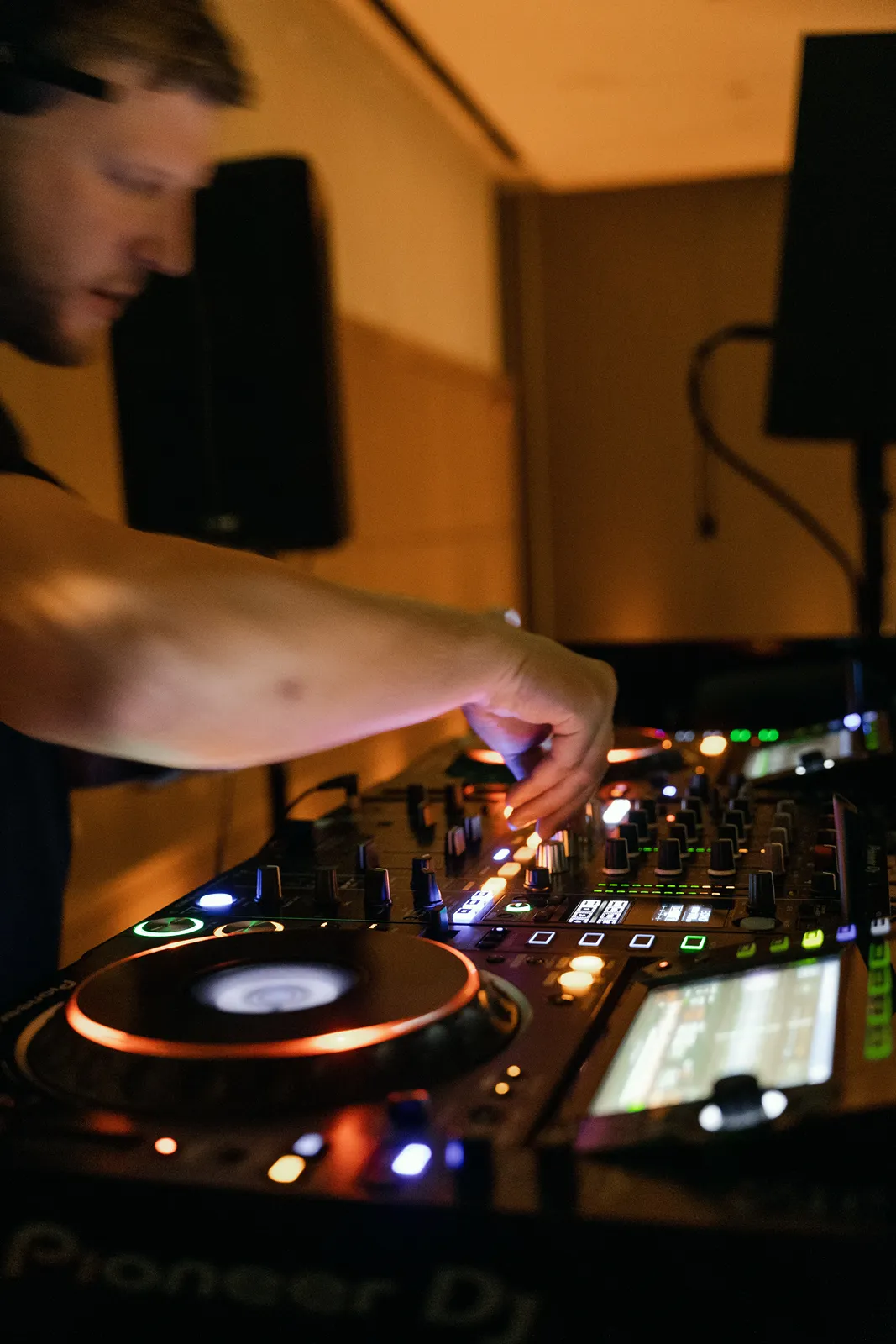 DJ adjusts mixer and turntables while providing music for a stylish wedding after-party