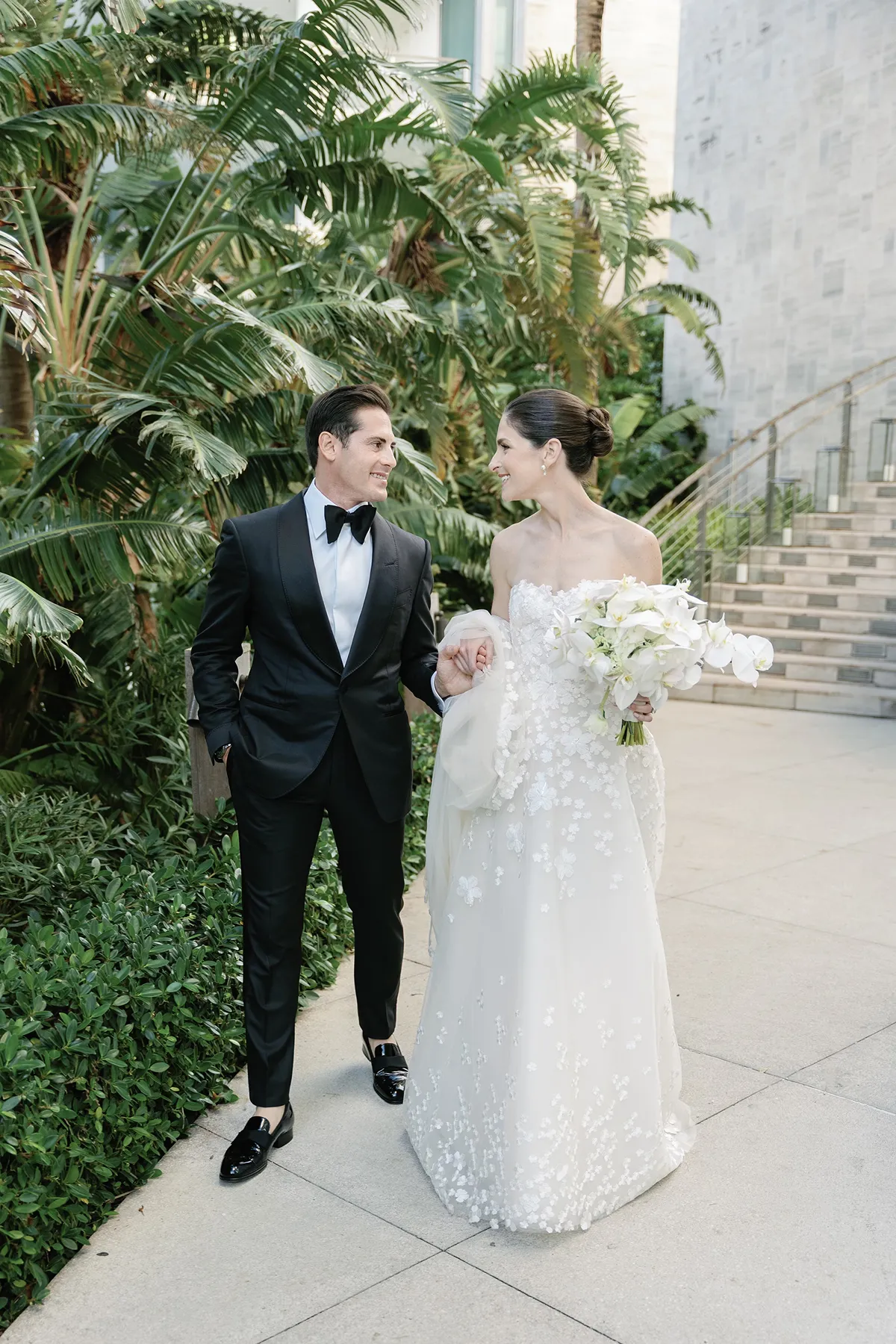bride and groom walking hand in hand during wedding portraits in the edition Miami Beach hotel