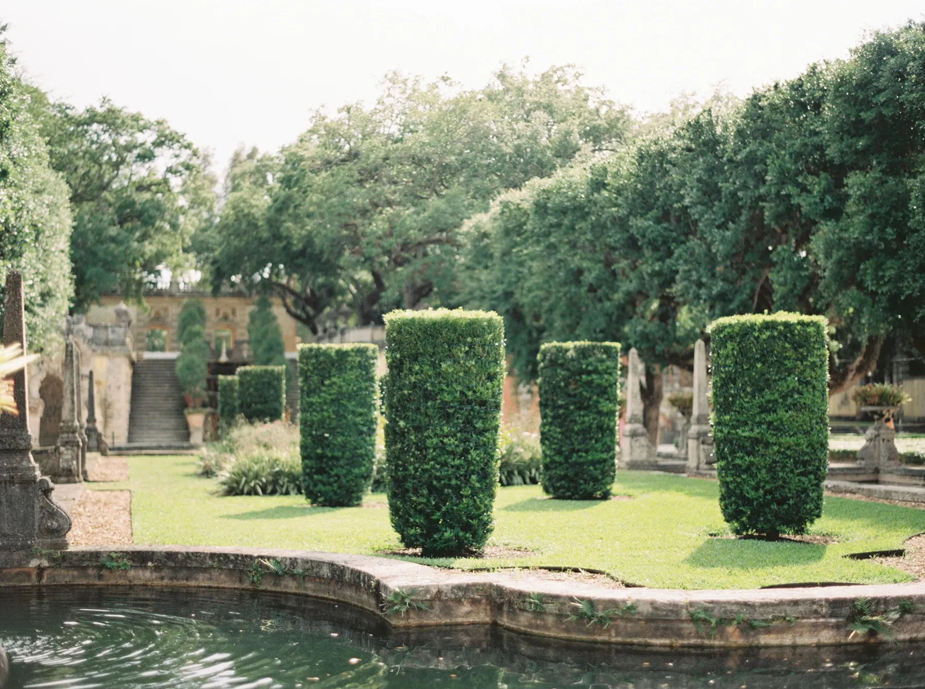 Manicured hedges and reflecting pool in the formal gardens at Vizcaya Museum & Gardens