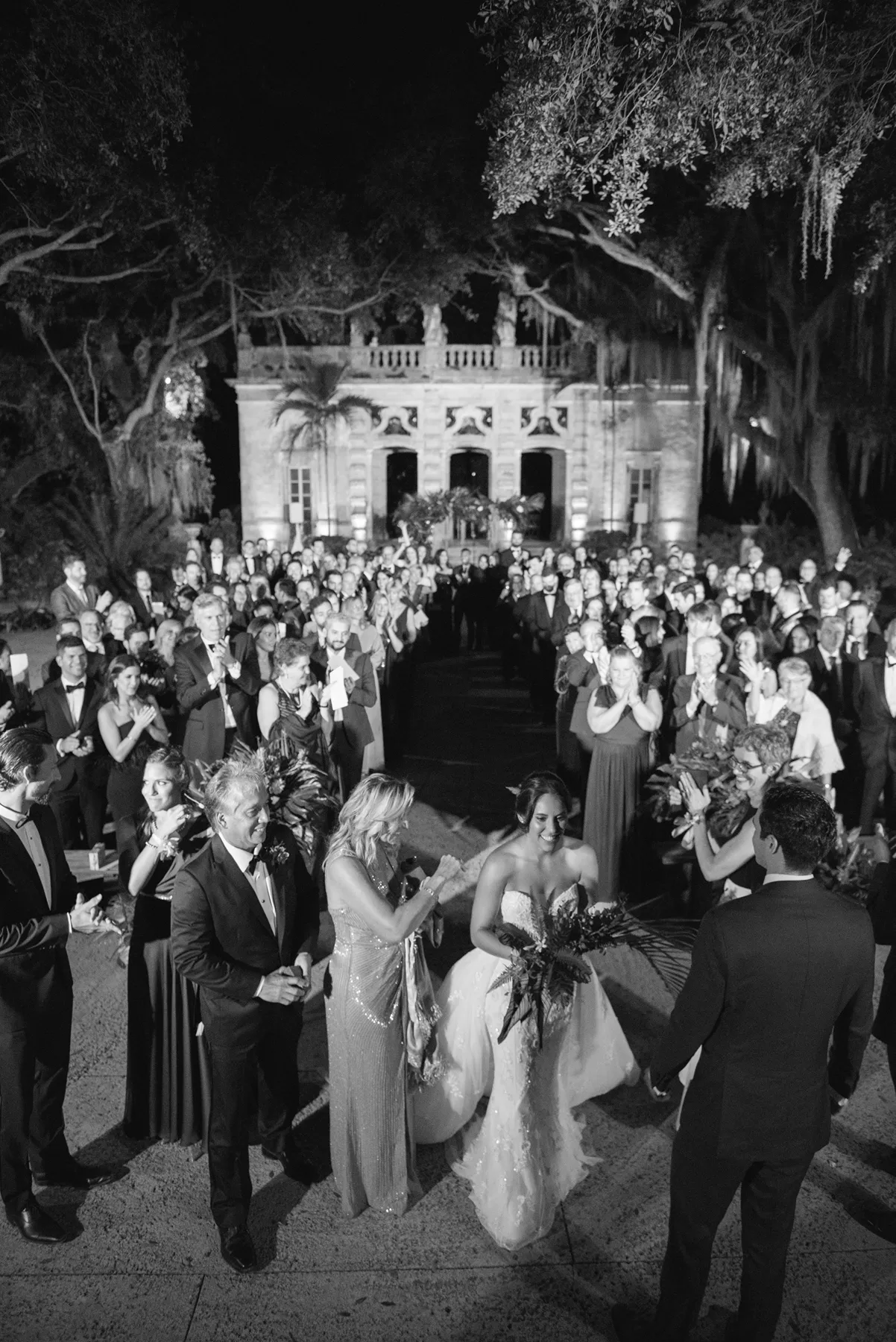 Wedding ceremony recessional surrounded by guests at Vizcaya Museum & Gardens
