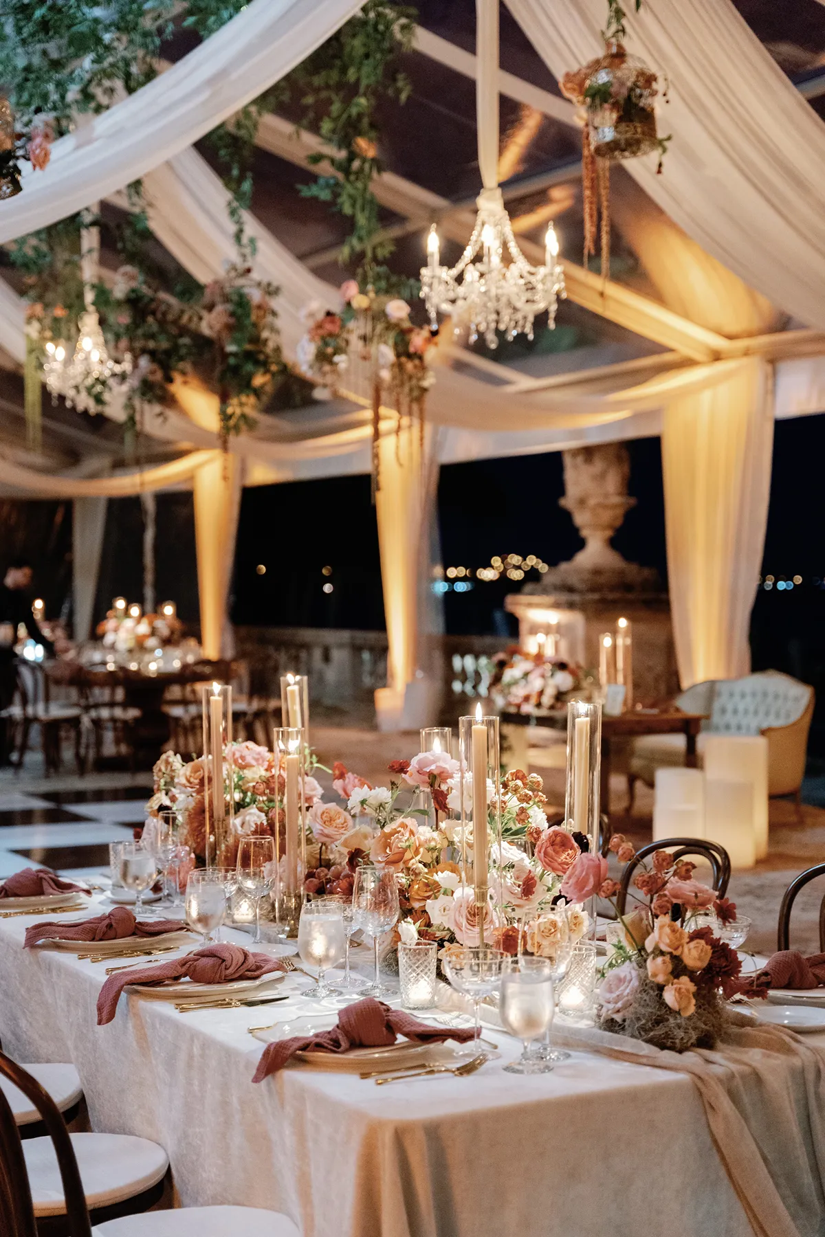 Romantic tented wedding reception with chandeliers and candlelight at Vizcaya Museum & Gardens